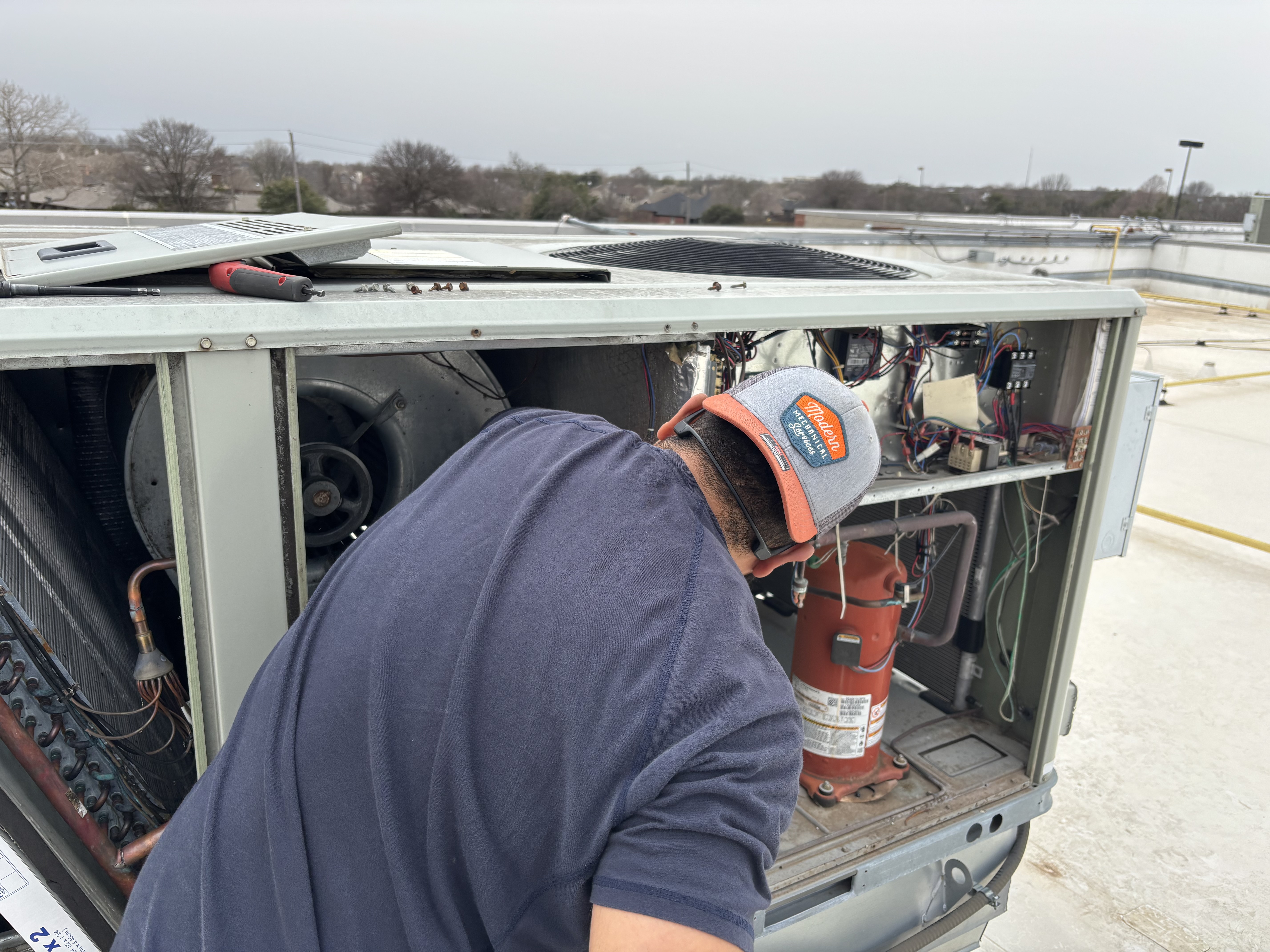MMS technician servicing rooftop unit